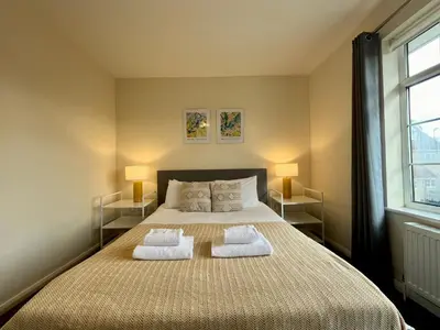 a bedroom with a large bed with two pillows at CENTRAL, newly refurb 2 bed flat with FREE PARKING in Cambridge