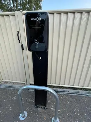 a black parking meter with a chair in front of it at CENTRAL, newly refurb 2 bed flat with FREE PARKING in Cambridge