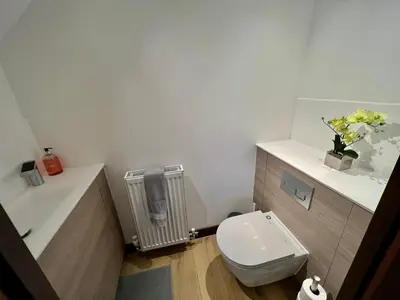 a bathroom with a white toilet and a radiator at Walnut Tree Penthouse Next to Train Station in Cambridge