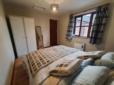a bedroom with a large bed with pillows on it at Cosy Barn Conversion 3BR (4 pax), Quiet, Close to Pin Mill in Chelmondiston