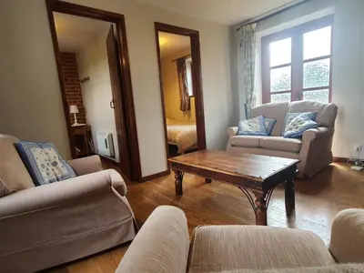 a living room with couches and a coffee table at Cosy Barn Conversion 3BR (4 pax), Quiet, Close to Pin Mill in Chelmondiston