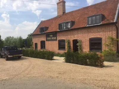 a brick house with a truck parked in front of it at SkyFall in Grundisburgh