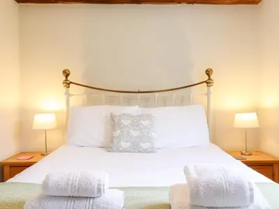 a bedroom with a bed with two towels on it at The Brambles in Colchester