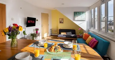 a living room with a table and a blue couch at R&O Property Experts - Diamond 2BR Apartment-Central-Parking-Walk to city & train station in Cambridge
