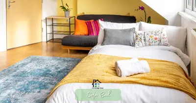 a bedroom with a bed and a couch at R&O Property Experts - Diamond 2BR Apartment-Central-Parking-Walk to city & train station in Cambridge