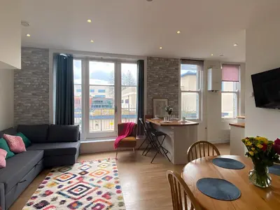 a living room with a couch and a table at R&O Property Experts - Diamond 2BR Apartment-Central-Parking-Walk to city & train station in Cambridge