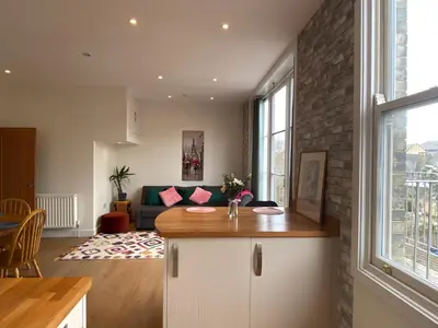 a kitchen and living room with a couch and a table at R&O Property Experts - Diamond 2BR Apartment-Central-Parking-Walk to city & train station in Cambridge
