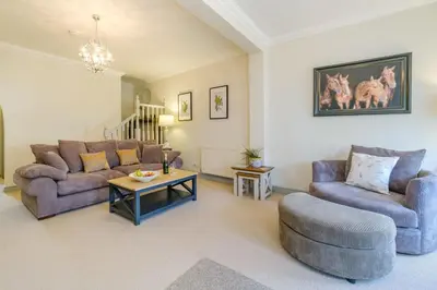 a living room with two couches and a table at Shearwater Cottage in Aldeburgh