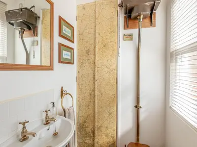 a bathroom with a shower and a sink at The Old Parish Hall in Quendon