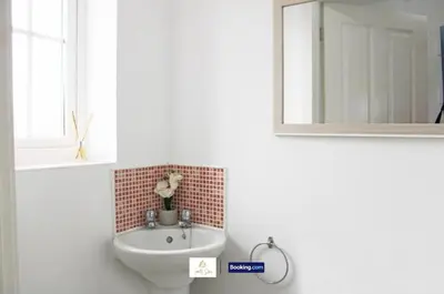 a bathroom with a sink and a mirror at 3 Bedroom House By Trinity Stays Short Lets & Serviced Accommodation Cambridge With Free WiFi & Parking in Cambridge