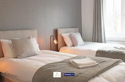 a bedroom with two beds with towels on them at 3 Bedroom House By Trinity Stays Short Lets & Serviced Accommodation Cambridge With Free WiFi & Parking in Cambridge