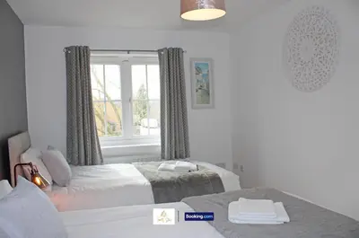 a bedroom with two beds and a window at 3 Bedroom House By Trinity Stays Short Lets & Serviced Accommodation Cambridge With Free WiFi & Parking in Cambridge