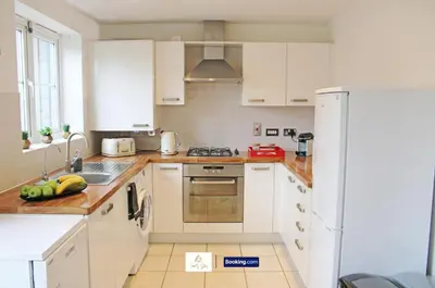 a white kitchen with a sink and a refrigerator at 3 Bedroom House By Trinity Stays Short Lets & Serviced Accommodation Cambridge With Free WiFi & Parking in Cambridge
