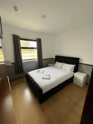 a bedroom with a large bed with a window at Stay Inn Express, Cambridge in Cambridge