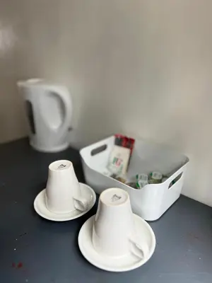 two stacks of white dishes sitting on a table with a container at Stay Inn Express, Cambridge in Cambridge