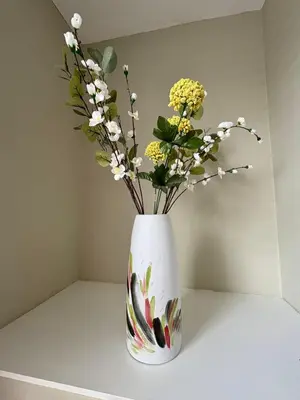 a vase filled with flowers sitting on a table at Stylish Town House in Medieval Grid in Bury Saint Edmunds