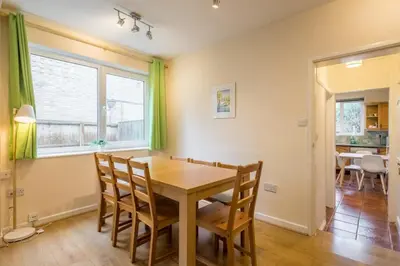 a dining room with a wooden table and chairs at 4 Bed Central Home - Perfect Location with Parking in Cambridge
