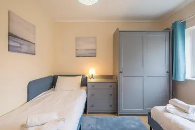 a small bedroom with a bed and a dresser at 4 Bed Central Home - Perfect Location with Parking in Cambridge