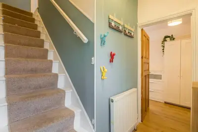 a staircase in a home with a hallway with a stair case at 4 Bed Central Home - Perfect Location with Parking in Cambridge