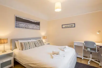a bedroom with a bed and a desk and a chair at 4 Bed Central Home - Perfect Location with Parking in Cambridge