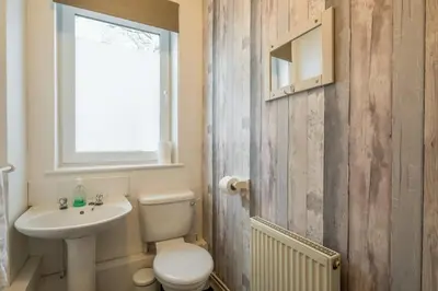a bathroom with a white toilet and a sink at 4 Bed Central Home - Perfect Location with Parking in Cambridge