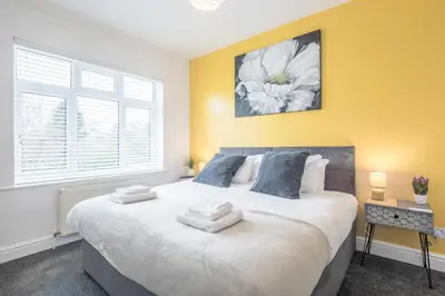a bedroom with a large bed with towels on it at The Modern Cambridge Studio 5 in Cambridge