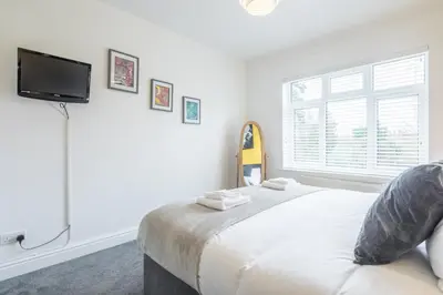 a bedroom with a bed and a tv and a window at The Modern Cambridge Studio 5 in Cambridge