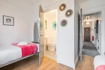 a small bedroom with a bed and a bathroom at The Modern Cambridge Studio 6 in Cambridge