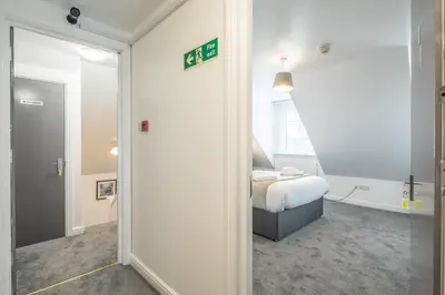 a bedroom with a bed in a room with a mirror at The Modern Cambridge Studio 7 in Cambridge