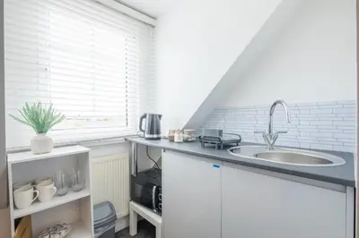 a kitchen with a sink and a counter top at The Modern Cambridge Studio 7 in Cambridge