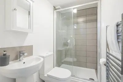 a bathroom with a toilet sink and a shower at The Modern Cambridge Studio 8 in Cambridge
