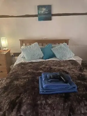 a bed with a blue tray on top of it at The Nutshell in West Mersea