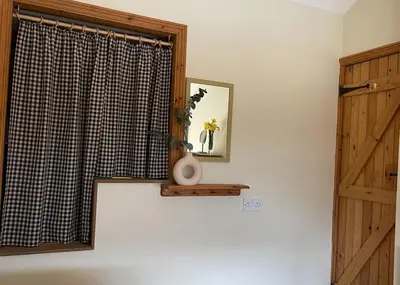 a room with a window with a vase on a shelf at Pretty Cottage in peaceful village location close To Cambridge in Cambridge