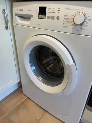 a white washing machine sitting in a kitchen at Pretty Cottage in peaceful village location close To Cambridge in Cambridge