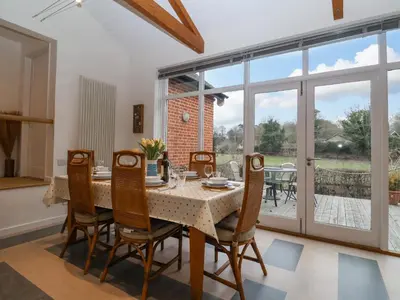 a dining room with a table and chairs at Valley Farm Cottage in Woodbridge