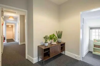 a living room with a table with plants on it at Cambridge 3 bedroom flat with private parking in Cambridge