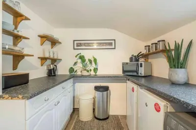 a kitchen with white cabinets and a counter top at Cambridge 3 bedroom flat with private parking in Cambridge