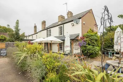 a building with a lot of plants in front of it at Cambridge 3 bedroom flat with private parking in Cambridge