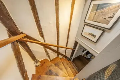 an overhead view of a wooden staircase in a house at Well Green Cottage in Wenhaston