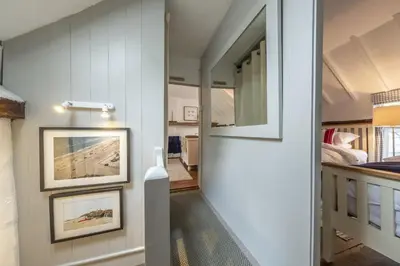 a hallway of a house with two pictures on the wall at Well Green Cottage in Wenhaston