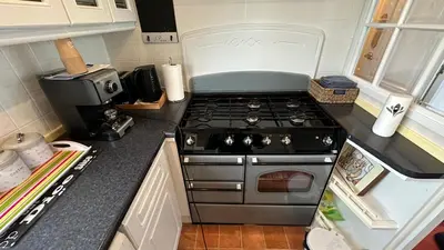 a kitchen with a stove top oven sitting on a counter at Freedom House in Clacton-on-Sea