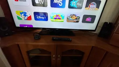 a flat screen tv sitting on top of a wooden cabinet at Freedom House in Clacton-on-Sea