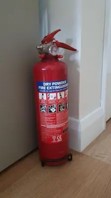 a red fire hydrant sitting on the floor next to a wall at Self-contained annex with private entrance, double bed, kitchen, bathroom, free car park - Near Cambridge, Duxford Air Museum and Addenbrooke's Hospital in Cambridge
