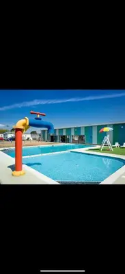 a picture of a swimming pool in front of a building at Serenity Holiday Home in Saint Osyth