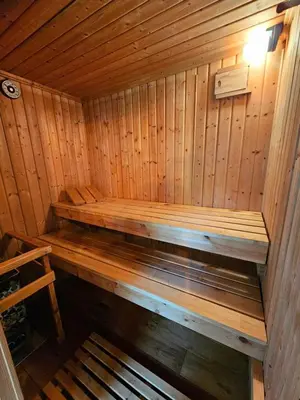 a wooden sauna with a bench in it at Luxury Self-Catering and Sauna - Oaks Rest in Colchester