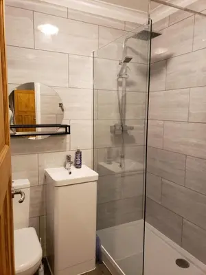 a bathroom with a shower and a toilet and a sink at Luxury Self-Catering and Sauna - Oaks Rest in Colchester
