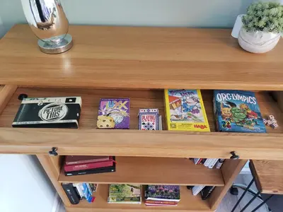 a wooden shelf with books and books at Luxury Self-Catering and Sauna - Oaks Rest in Colchester