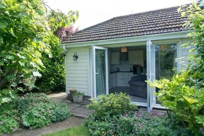 a garden room with a sliding glass door at Luxury Self-Catering and Sauna - Oaks Rest in Colchester