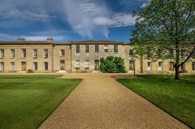 a large building with a pathway in front of it at Downing College in Cambridge
