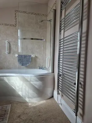 a bathroom with a white tub and a shower at Primroses, Wood Farm in Shipdham